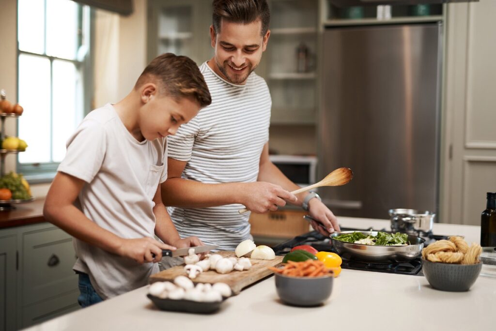 Father and son cooking together
